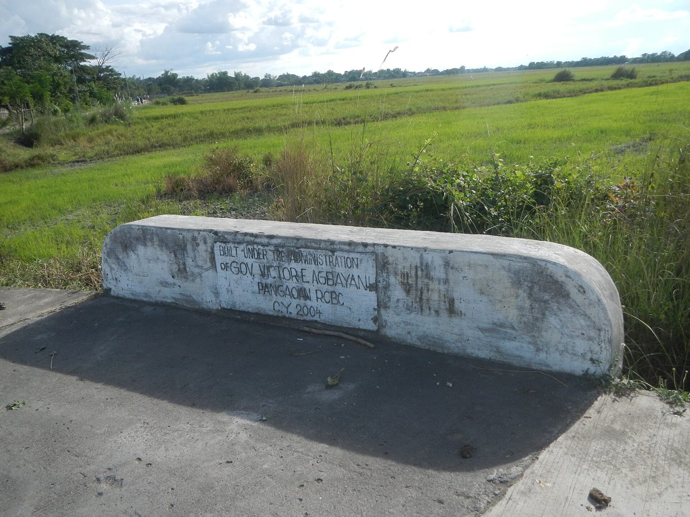 Concrete box culvert outlet in a rural drainage channel.